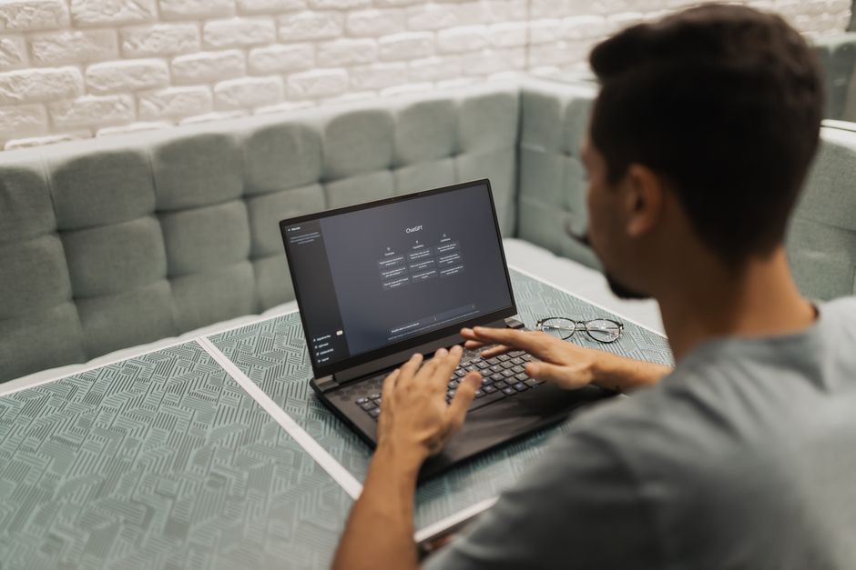 Professional using AI decision intelligence software on laptop in modern workspace.