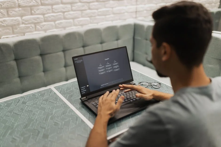 Professional using AI decision intelligence software on laptop in modern workspace.