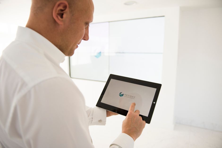 Professional using digital tablet for AI decision making in modern workspace, Suprmind.