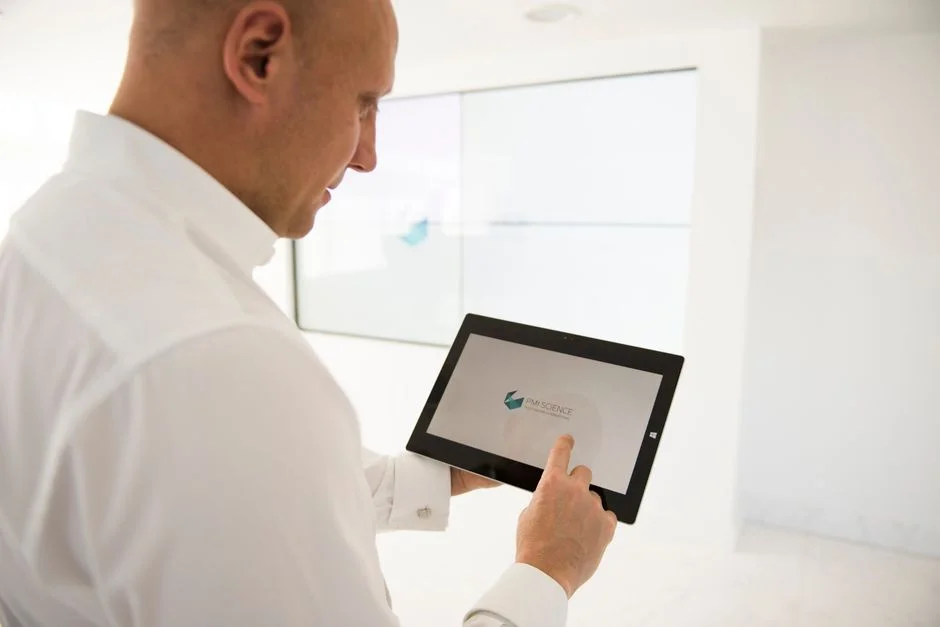Professional using digital tablet for AI decision making in modern workspace, Suprmind.