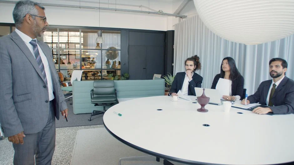 Business meeting in modern office, discussing AI decision intelligence by Suprmind.