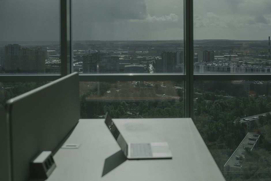 Modern workspace with laptop, city view, AI decision intelligence by Suprmind.